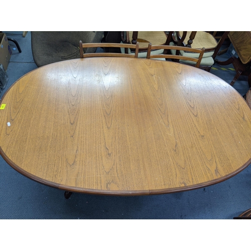 330 - A G plan teak oval draw leaf dining table and a set of six G plan dining chairs (table 206cm extende... 