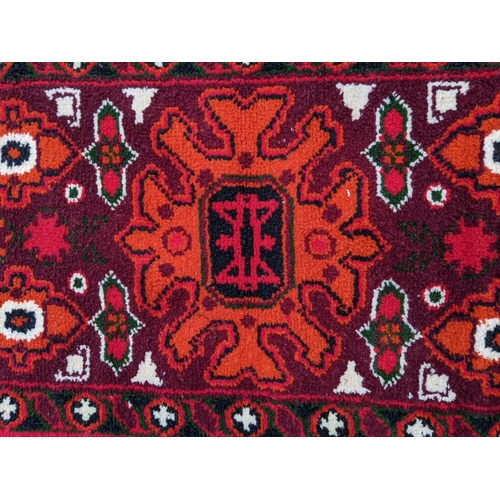 332 - Two rugs, one with a central floral decoration in a white emblem with white repeating border and an ... 