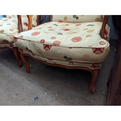 373 - A pair of modern walnut finished armchairs, upholstered in a beige fabric on cabriole legs
Location:... 