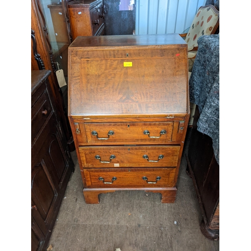 374 - An early 20th century mahogany ladies bureau with three long drawers, on bracket feet, 95cm h x 57cm... 