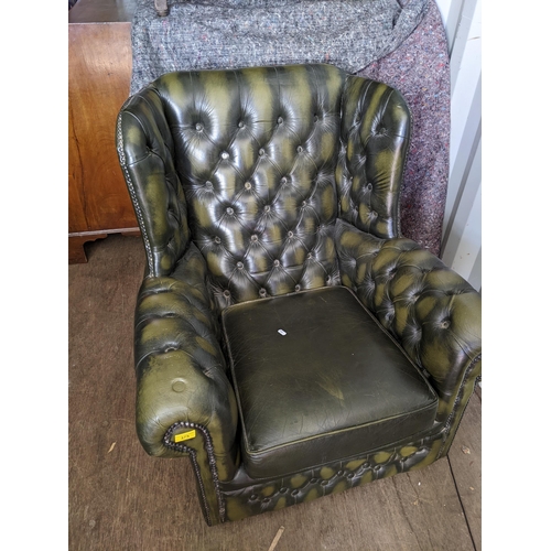 375 - A late 20th century green leather button upholstered Chesterfield style wing back armchair
Location:... 