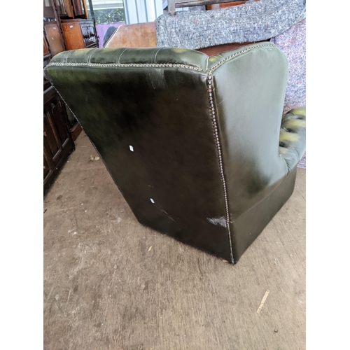 375 - A late 20th century green leather button upholstered Chesterfield style wing back armchair
Location:... 