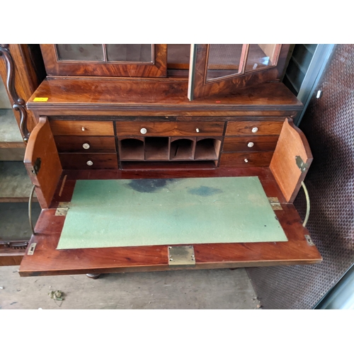 379 - A Victorian mahogany secretaire bookcase with a pair of glazed doors, over a drawer and two doors, o... 