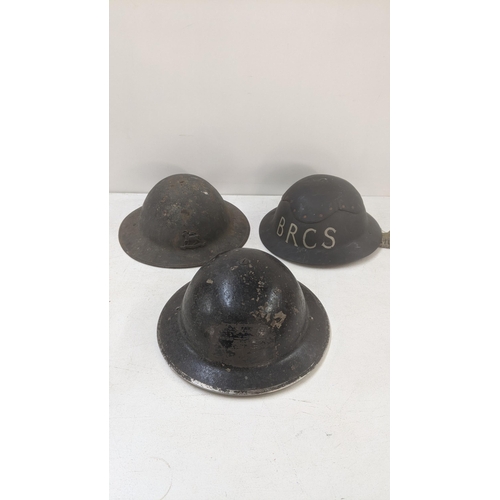 439 - Three British war time helmets to include a British Red Cross example Location:LWB
If there is no co... 