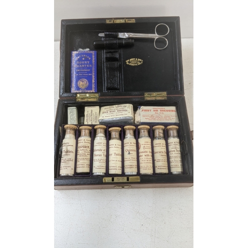 440 - An Army and Navy First Aid kit stored in a leather bound case made in Victoria Street Westminster Lo... 