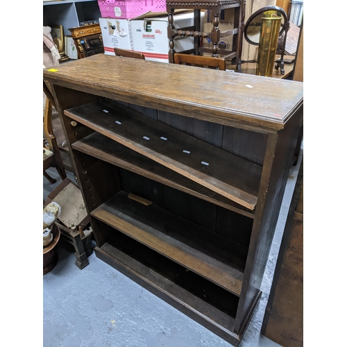 448 - Two 20th century bookcases, an oak open bookcase with three adjustable shelves on plinth base 107cm ... 