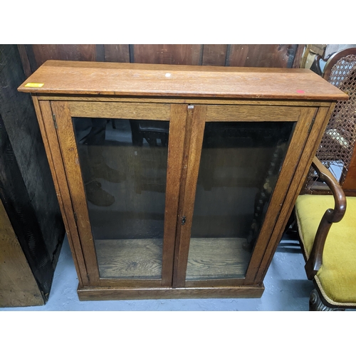 448 - Two 20th century bookcases, an oak open bookcase with three adjustable shelves on plinth base 107cm ... 