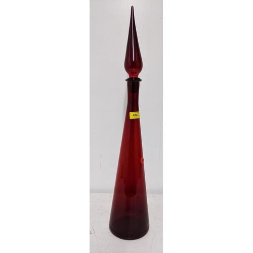 454 - A mid century ruby glass genie bottle with spire stopper, 72cm high Location:RAF
If there is no cond... 