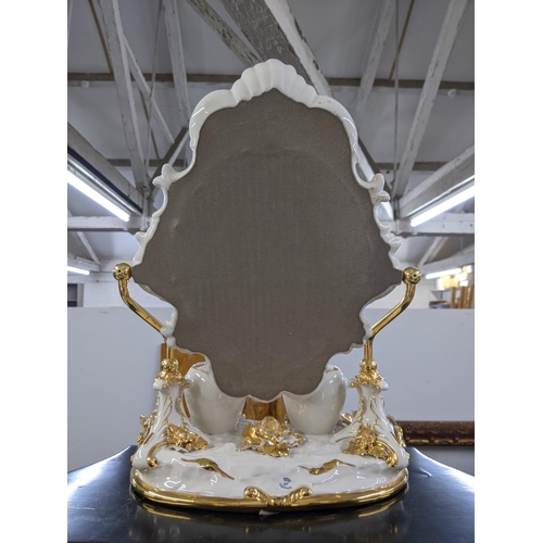 490 - A modern bathroom swivel ceramic mirror decorated with flowers and gilding with two pots in front of... 