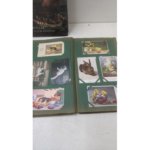 469 - A mixed lot to include three vintage postcard albums together with Fighting Ships 1750 by Sam Willis... 