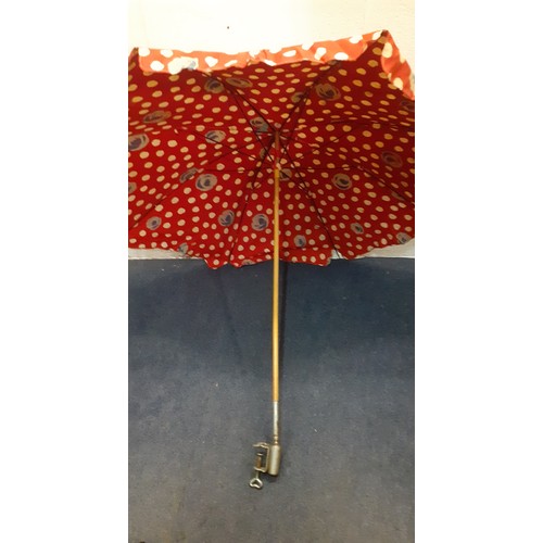 169 - A mid 20th Century large cotton tabletop parasol in red with wooden handle and metal clamp, approx 1... 