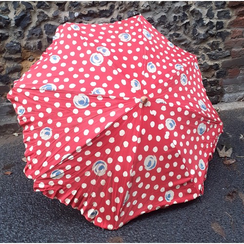 169 - A mid 20th Century large cotton tabletop parasol in red with wooden handle and metal clamp, approx 1... 