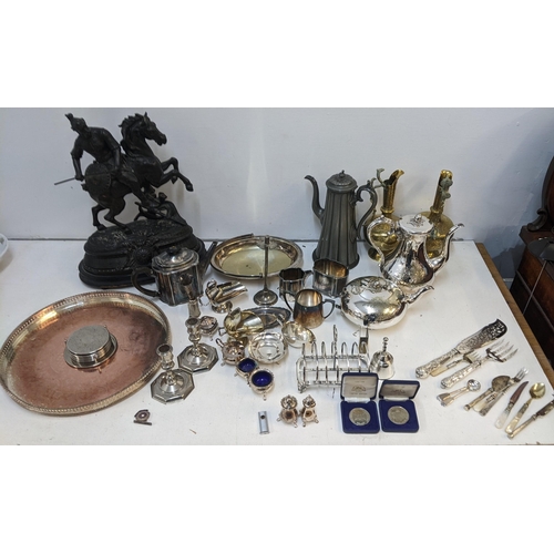 458 - A collection of metalware to include an early 20th century spelter figure of a warrior on a horse, t... 