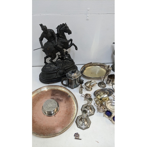 458 - A collection of metalware to include an early 20th century spelter figure of a warrior on a horse, t... 