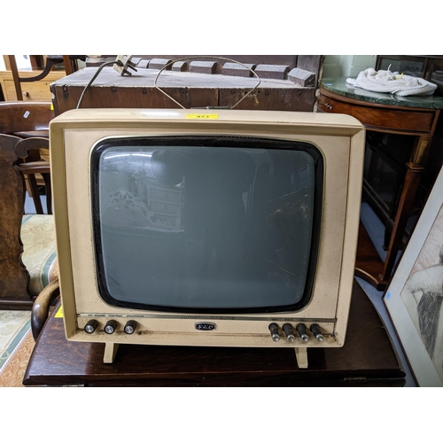 471 - A GEC Junior Fineline television with white plastic casing, black control buttons and a separate aer... 