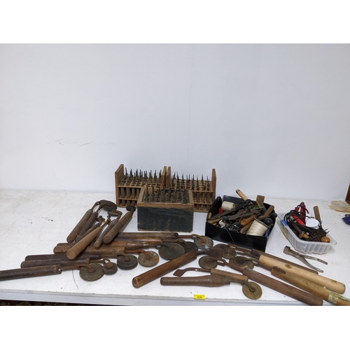 476 - A selection of bookbinders/printers tools, letter stamps and accessories tools, along with a paper c... 