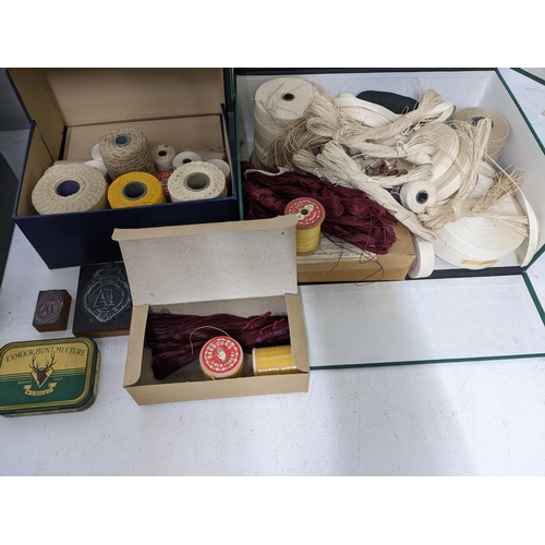 477 - A selection of bookbinders satin cords and linen threads, vintage tins, print blocks, and other item... 