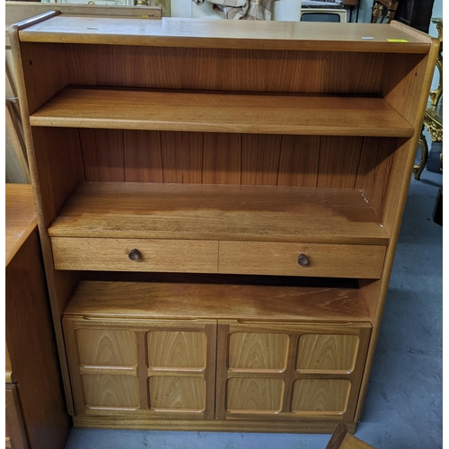 537 - A Parker Knoll mid century teak bookcase, open shelves above two drawers, twin base cupboard doors w... 