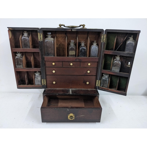 512 - An early 20th century mahogany portable medicine cabinet with nine glass bottles
Submission referenc... 