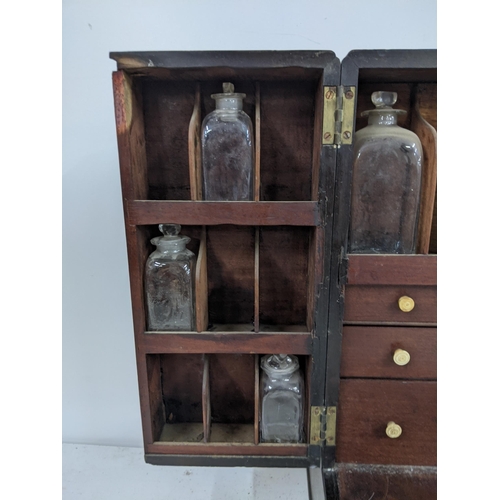 512 - An early 20th century mahogany portable medicine cabinet with nine glass bottles
Submission referenc... 