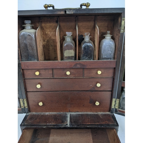 512 - An early 20th century mahogany portable medicine cabinet with nine glass bottles
Submission referenc... 