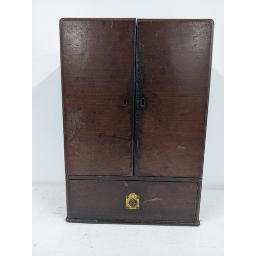 512 - An early 20th century mahogany portable medicine cabinet with nine glass bottles
Submission referenc... 