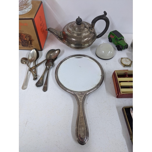 513 - A mixed lot to include silver plated spoons, teapot, mirror, cake forks and knives, together with tw... 