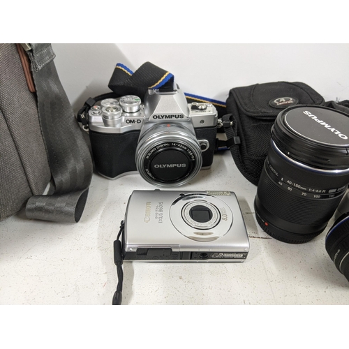 514 - Cameras and photographic equipment and accessories to include an Olympus OM-D, a Canon Digital IXU58... 