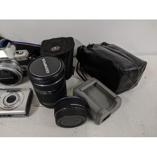 514 - Cameras and photographic equipment and accessories to include an Olympus OM-D, a Canon Digital IXU58... 