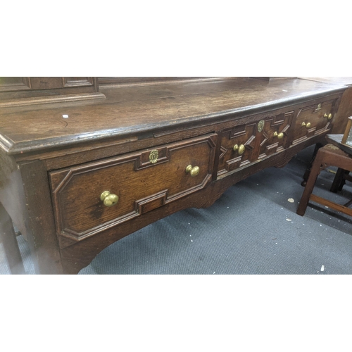 565 - Early 1700s oak dresser with shelves, pair of panelled doors, three in-line drawers on turned tapere... 