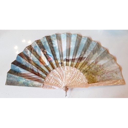 23 - An early 20th Century fan having 2 cream pearlised guards and 14 sticks A/F with hand-painted paper ... 