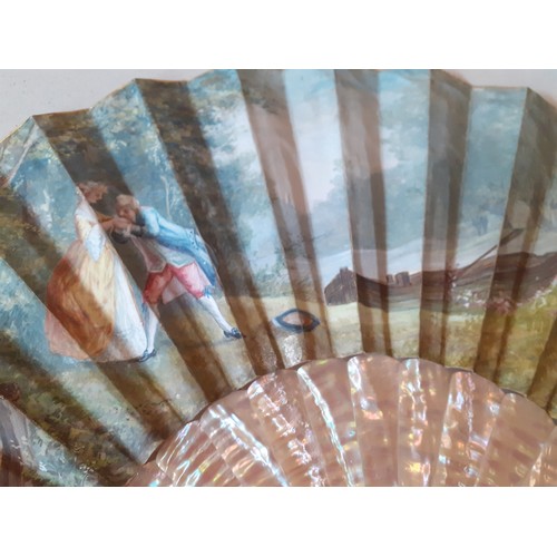 23 - An early 20th Century fan having 2 cream pearlised guards and 14 sticks A/F with hand-painted paper ... 