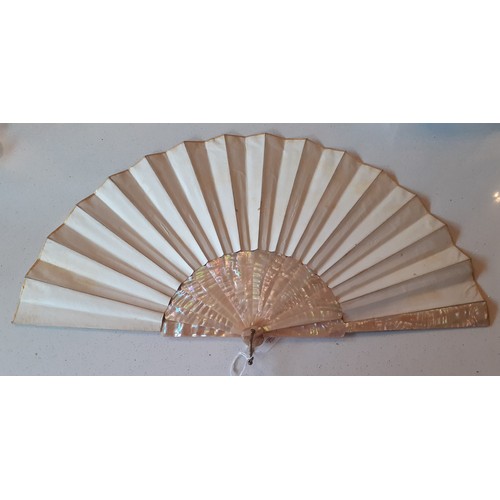 23 - An early 20th Century fan having 2 cream pearlised guards and 14 sticks A/F with hand-painted paper ... 