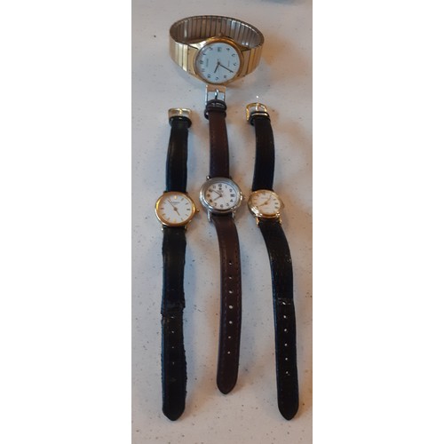 50 - Four watches comprising a ladies gold tone Tissot on black leather strap, a ladies gold tone Accuris... 