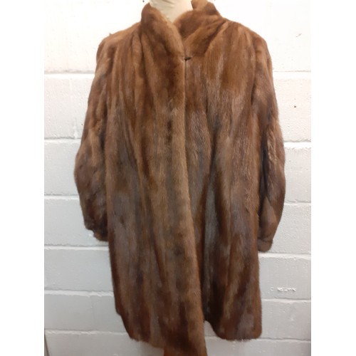 52 - A late 1970's/early '80's Saga brown mink hip length coat having bellow sleeves by JW Scott Furriers... 