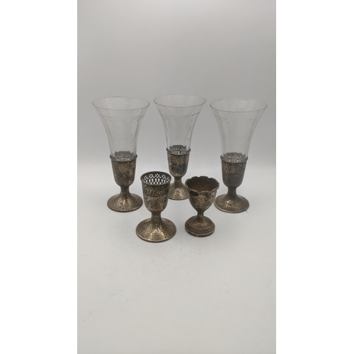 118 - Three sterling silver cut glass vases, along with one extra base, along with a silver eggcup, total ... 