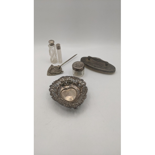 134 - Silver dressing table items to include two silver lidded scent bottles and pot, a nail buffer and a ... 