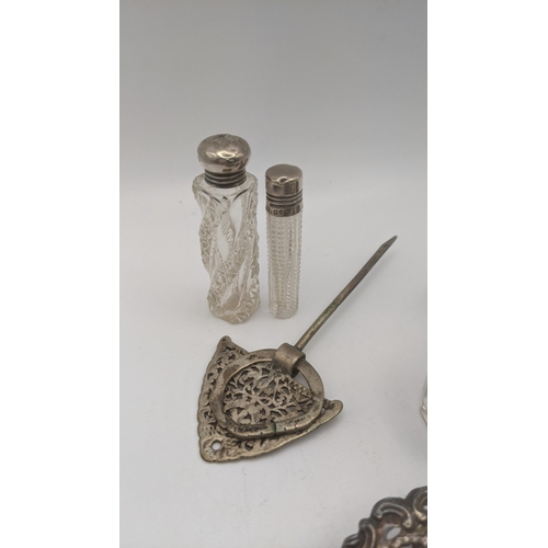 134 - Silver dressing table items to include two silver lidded scent bottles and pot, a nail buffer and a ... 