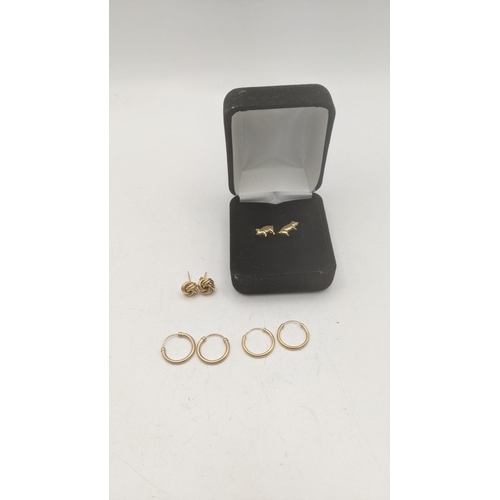 147 - Three pairs of 9ct gold earrings to include a pair fashioned as pigs, two pairs of 9ct gold hoop ear... 