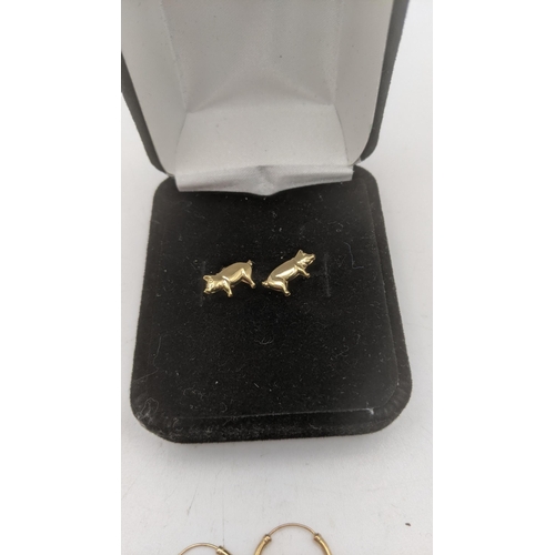 147 - Three pairs of 9ct gold earrings to include a pair fashioned as pigs, two pairs of 9ct gold hoop ear... 