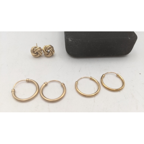 147 - Three pairs of 9ct gold earrings to include a pair fashioned as pigs, two pairs of 9ct gold hoop ear... 