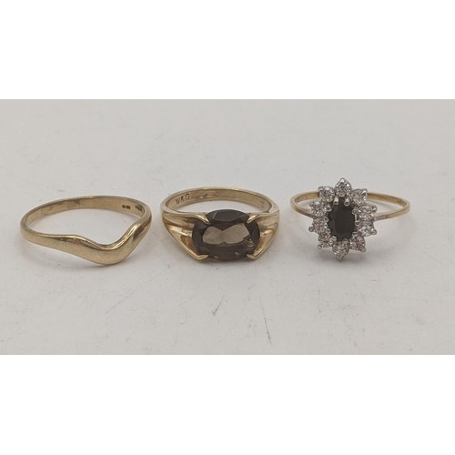 149 - Three 9ct yellow gold ladies rings to include a solitaire smoky quartz oval cut four claw set exampl... 