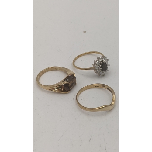 149 - Three 9ct yellow gold ladies rings to include a solitaire smoky quartz oval cut four claw set exampl... 