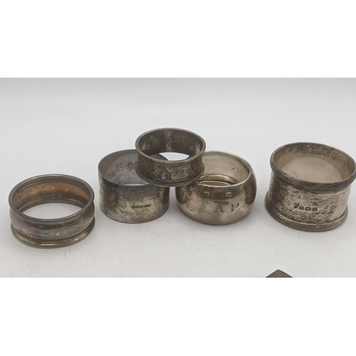 166 - A mixed lot of silver napkin table rings 107.9g, together with a silver framed photo frame in circul... 