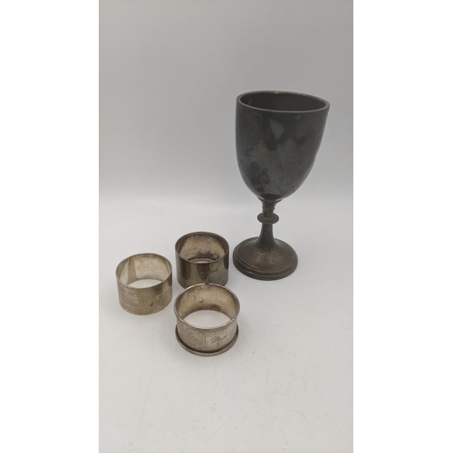 82 - Silver to include a goblet marked to Southgate County School, along with three napkin rings, total w... 