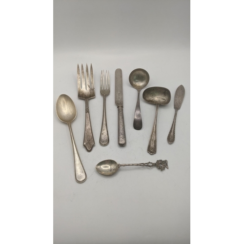 87 - Silver cutlery and flatware to include two sauce ladles, a butter knife with weighted handle, a ster... 