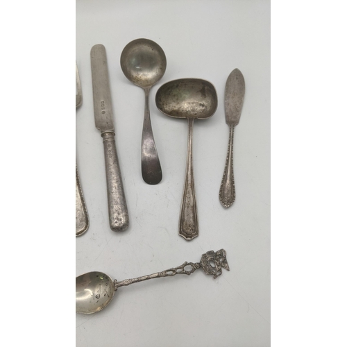 87 - Silver cutlery and flatware to include two sauce ladles, a butter knife with weighted handle, a ster... 