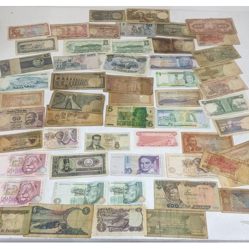 90 - Bank notes from around the world to include examples from China, France, Brazil, South Africa and ot... 