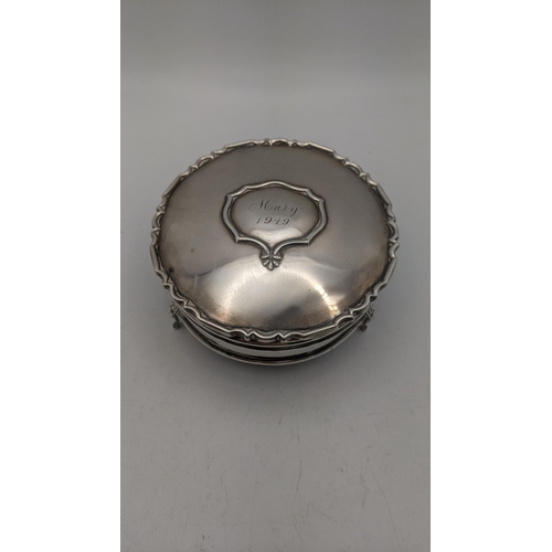 97 - A silver ring box on three feet, engraving to the lid Mary 1949, having a gilt and fabric interior
L... 