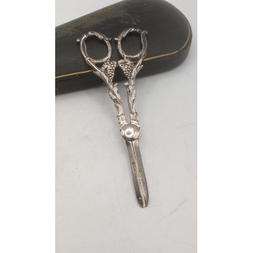 109 - A Levesley Brothers pair of silver grape scissors hallmarked Sheffield 1898 having cast vine and gra... 